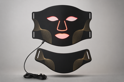 Aura Mask LED light therapy mask with neck attachment and USB charging cable on a soft grey background — Healing Circle